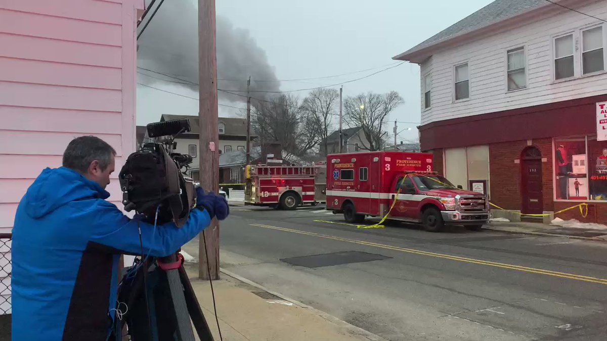 Plumes of smoke filling the air — possible fire on or near the scene. Large flames from the top of a home more gunshots are being fired off. Engines are heading in