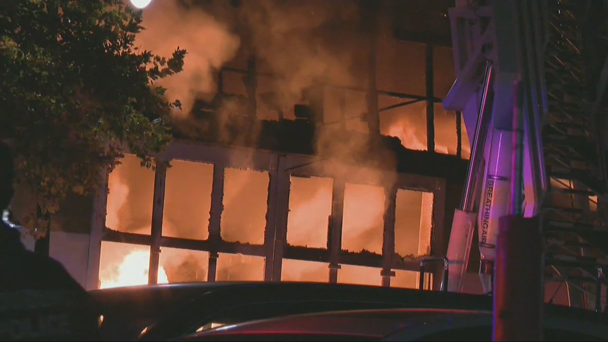 A massive fire damages a building near a popular bar in Providence and forces evacuations.