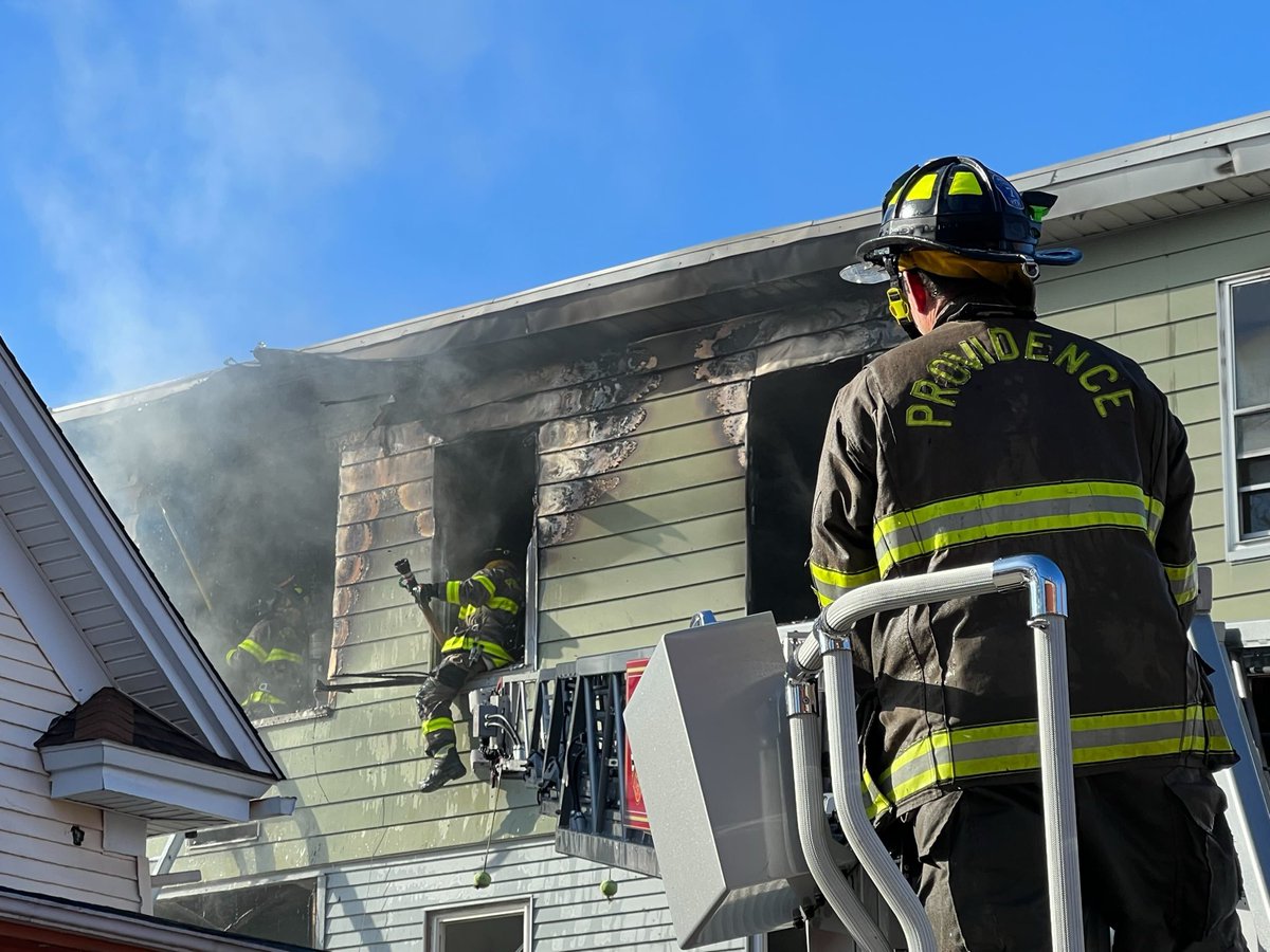 Providence firefighters continuing to work a house fire on Monticello Street